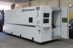 A large industrial Piranha laser cutting machine being positioned in IPI's Metal Shop.