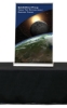 Tabletop retractable banner stand with space graphics displayed on a black table