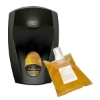 Black wall-mounted soap dispenser alongside a refill pouch of amber Indulgence foaming soap.