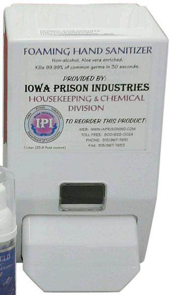 White wall-mounted Foaming Hand Sanitizer dispenser labeled Iowa Prison Industries with a push lever.