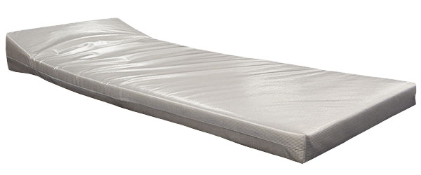 White mattress with a built-in elevated wedge pillow and clear security-view covering.