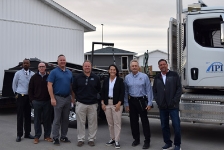 Lieutenant Governor Chris Cournoyer and others posed for a photo in front of the IPI truck at the Newton home building site 