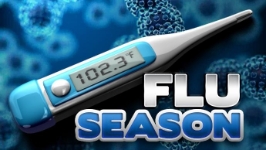 A digital thermometer reading 102.3°F lies above the bold text "FLU SEASON" against a dark blue background filled with microscopic virus cell illustrations.