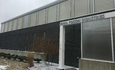 Front view of the Iowa Prison Industries showroom with snow on the ground