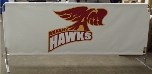 White barricade banner with a red Ankeny Hawks graphic with a yellow outline in the middle.