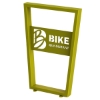 Yellow trapezoidal bike rack with surface mount feet at the bottom and a laser cut Bike Bondurant logo.